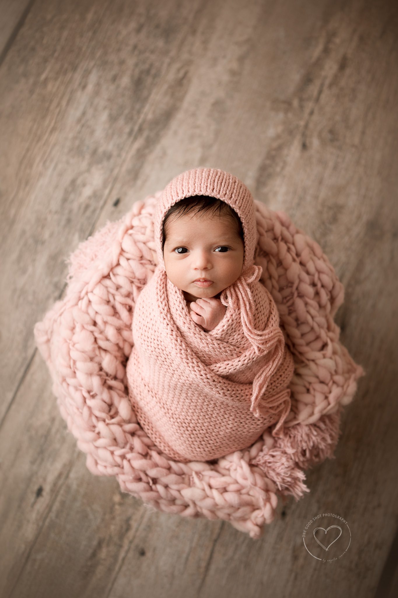 Newborn Photography, Baby awake, wrapped in pink, lying in bucket, bonnet