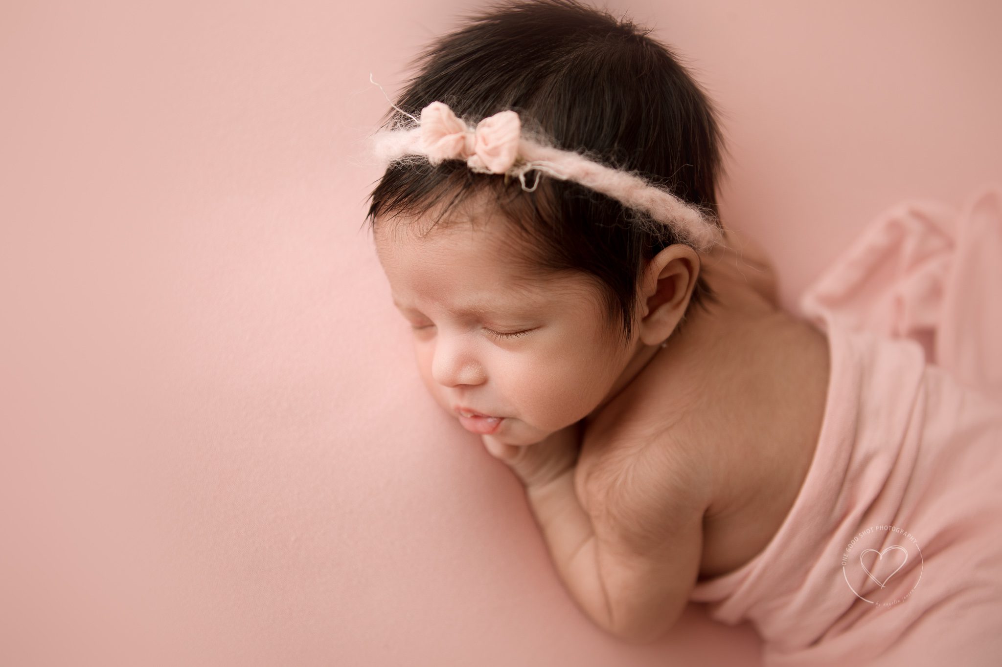 fresno newborn photographer, close up of baby lashes, pink background, pink bow