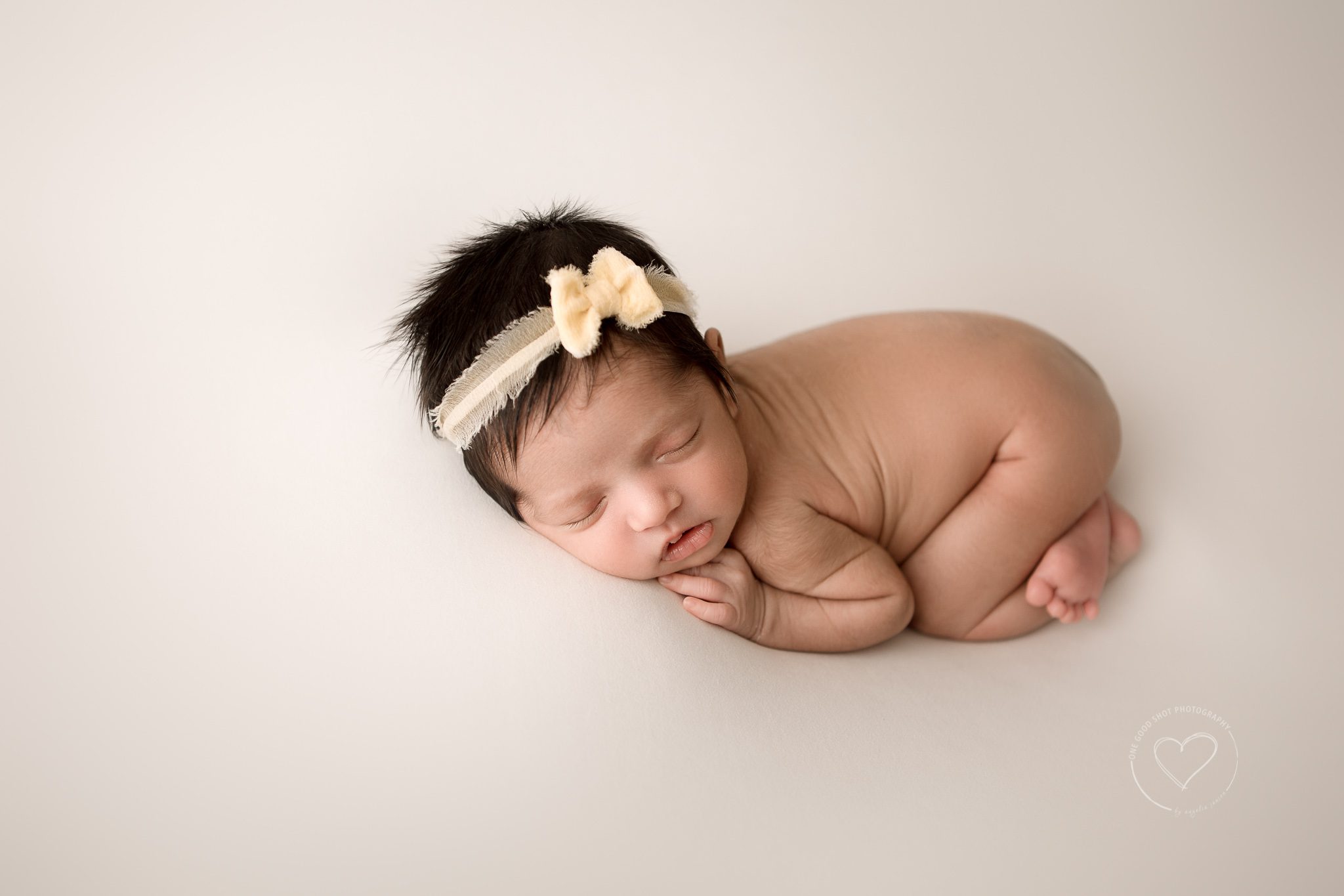 Fresno newborn photographer, bum up, tushy up pose yellow bow, white backdrop