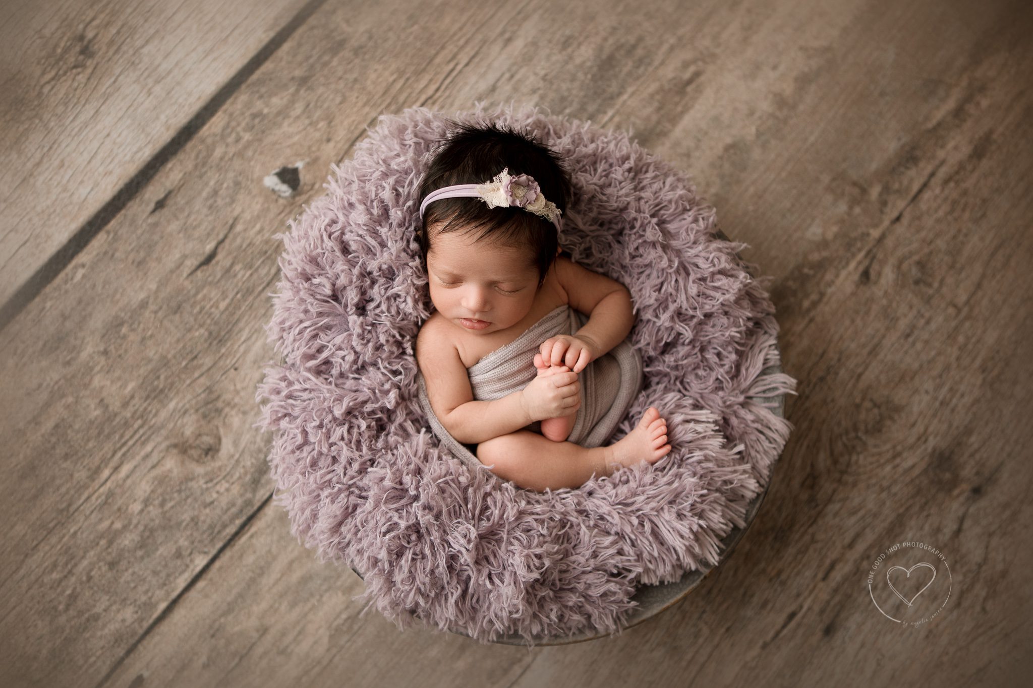 fresno clovis newborn photographer, baby girl, lavender props, wood floor backdrop, all the things pose, holding feet