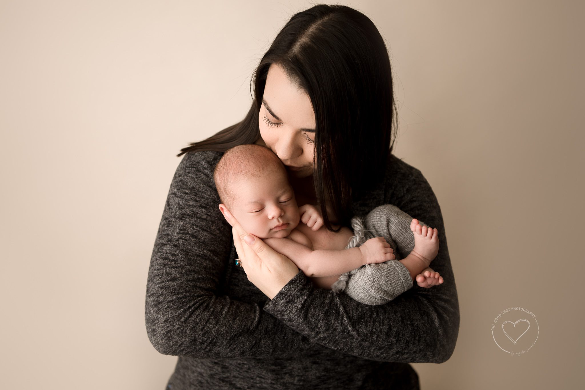 mom holding newborn baby in arms, fresno photographer 
