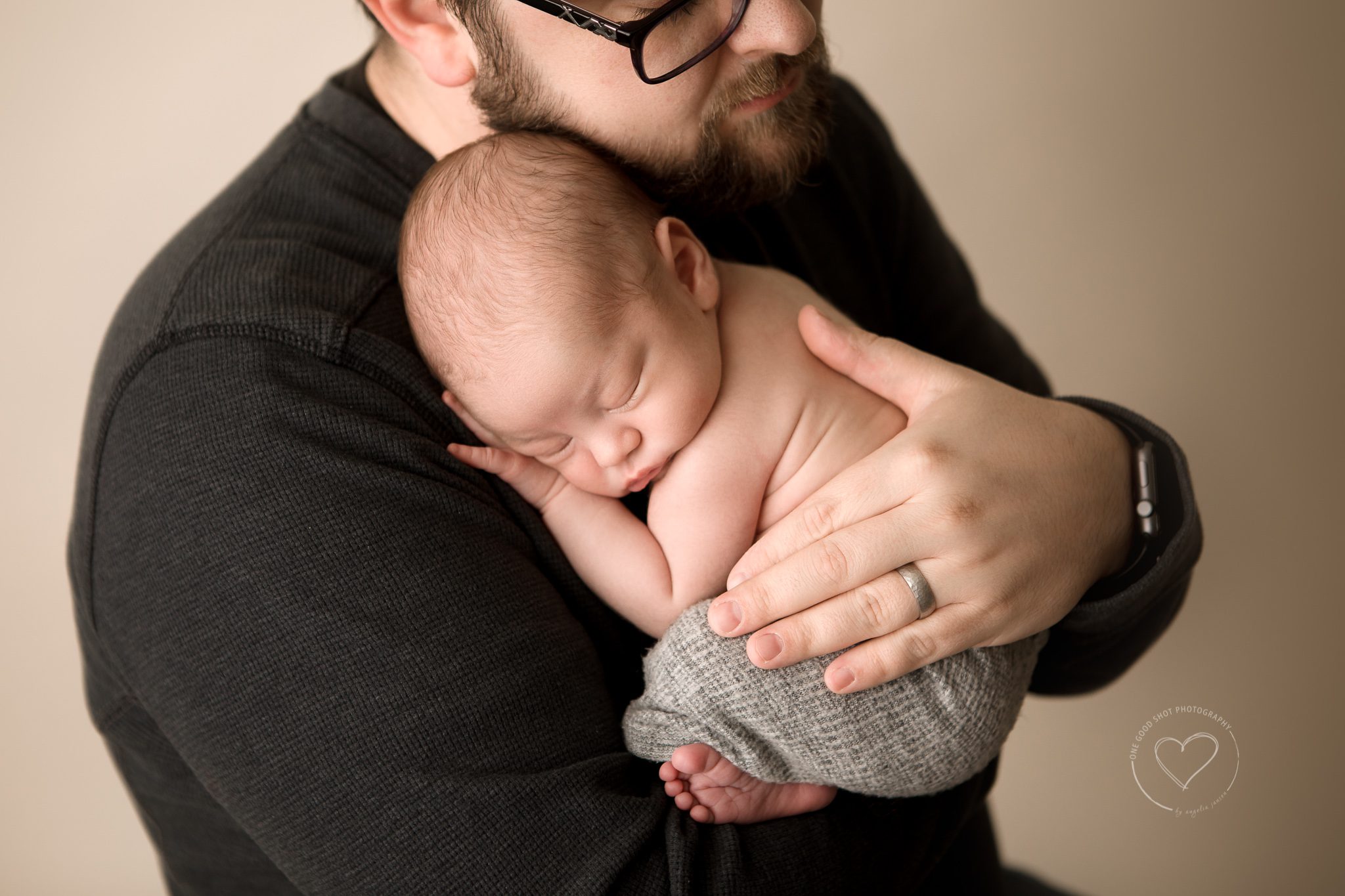 dad holing newborn baby, fresno photographer