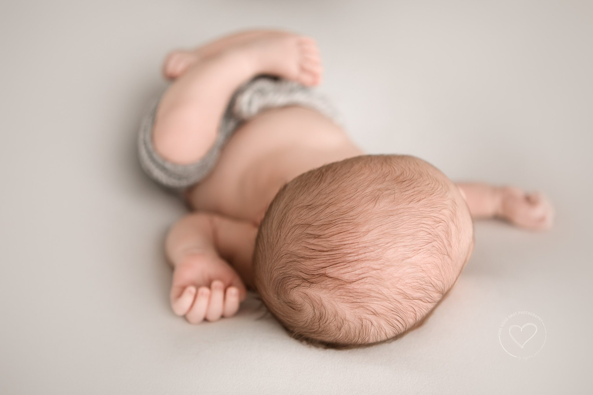 newborn boy wearing gray short, huck finn pose, top of head, fresno photographer, one good shot, 