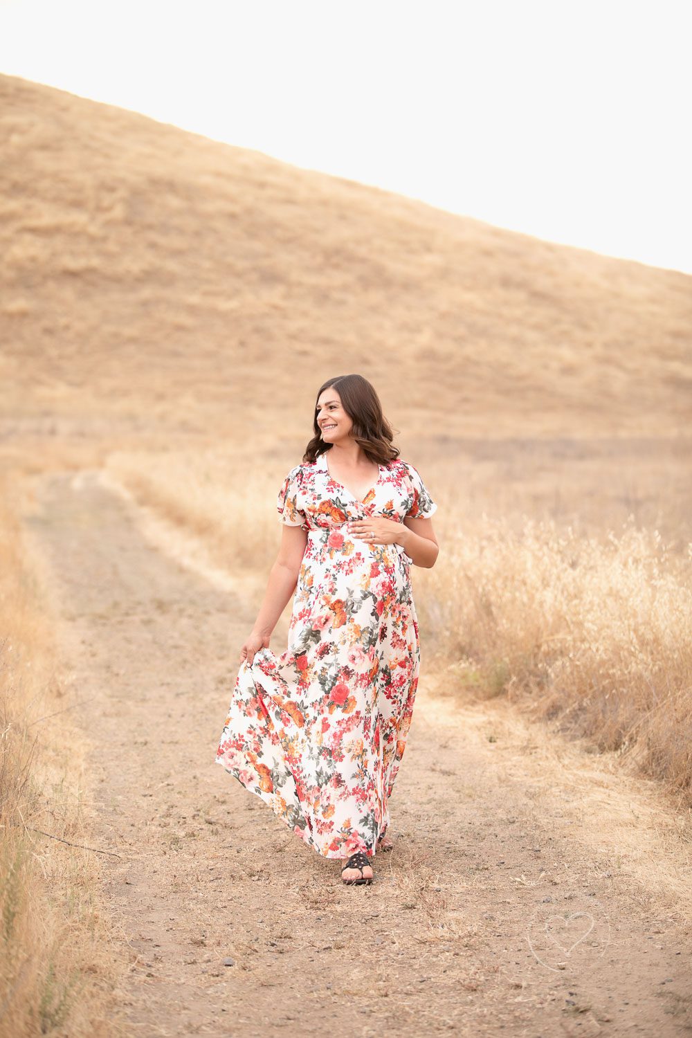 maternity, walking in floral dress smiling, fresno, clovis, photographer