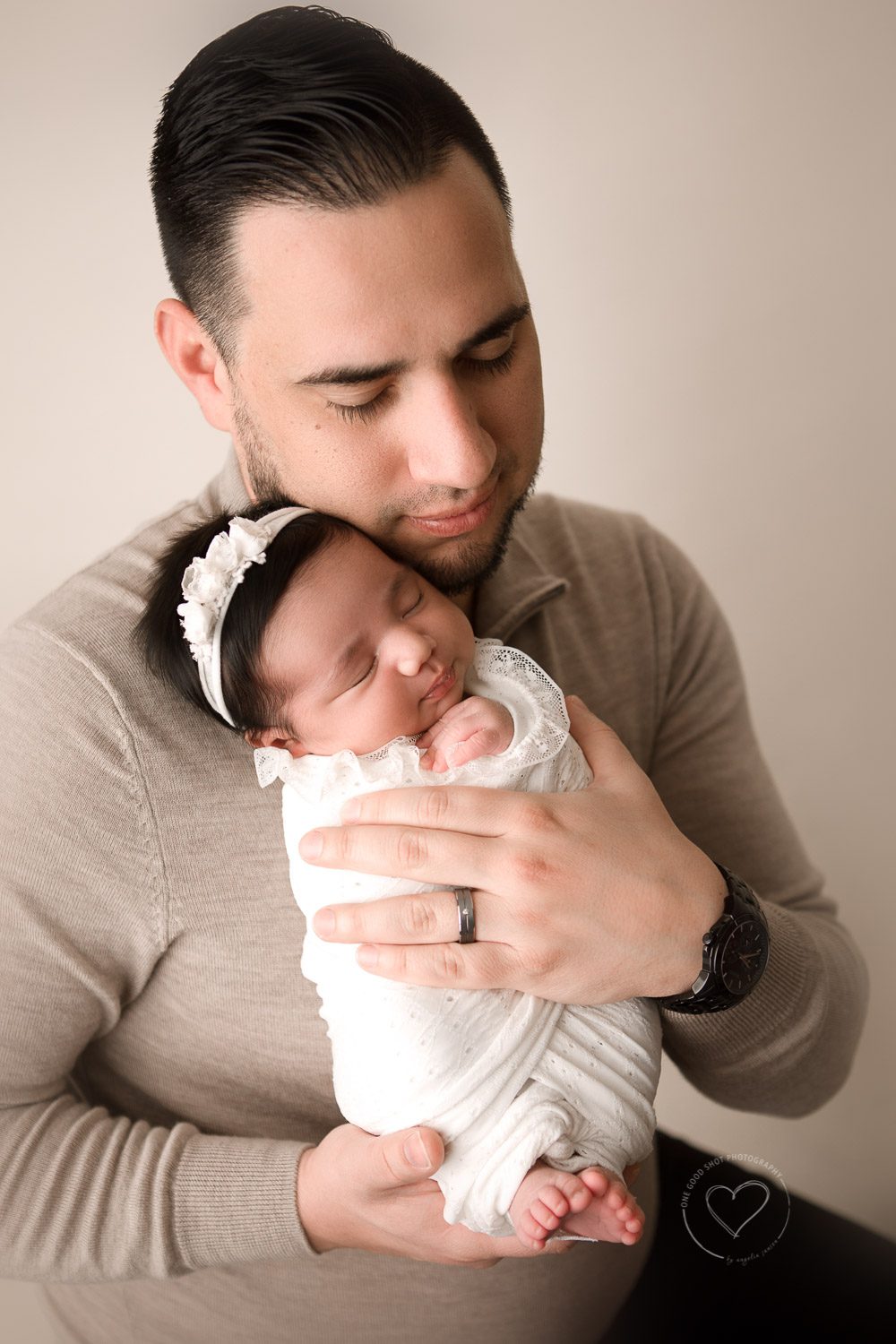 Newborn girl in dad's arms, love, neutrals, family, Fresno photograher